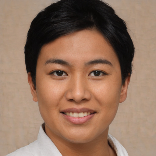 Joyful asian young-adult female with short  black hair and brown eyes
