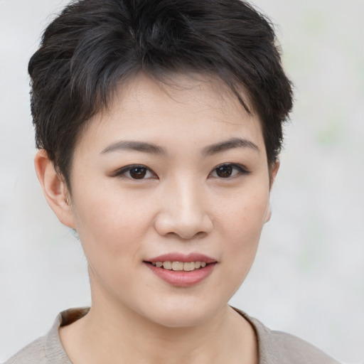 Joyful asian young-adult female with short  brown hair and brown eyes