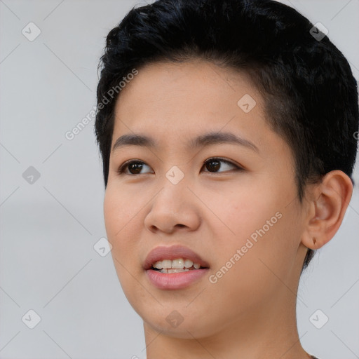 Joyful asian young-adult female with short  black hair and brown eyes