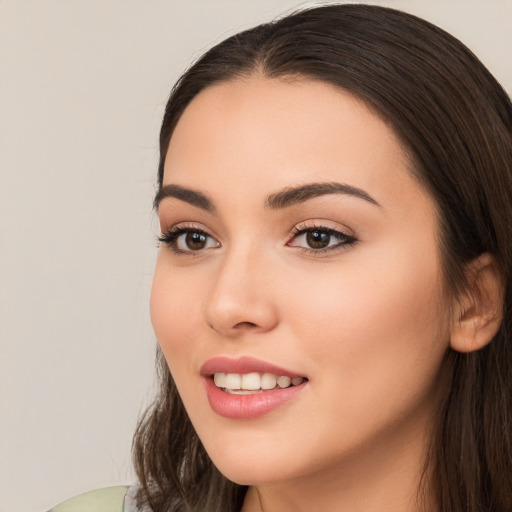 Joyful white young-adult female with long  brown hair and brown eyes