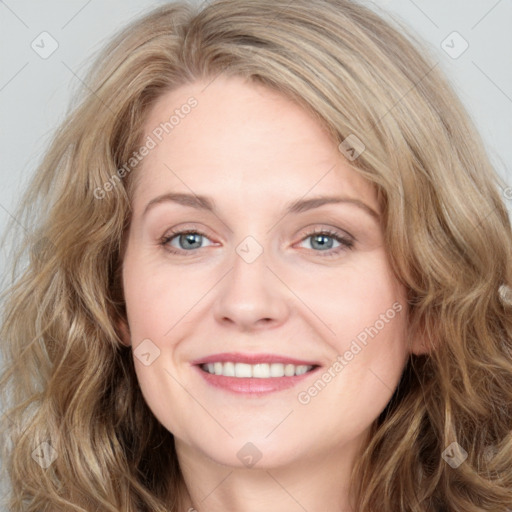 Joyful white young-adult female with long  brown hair and blue eyes