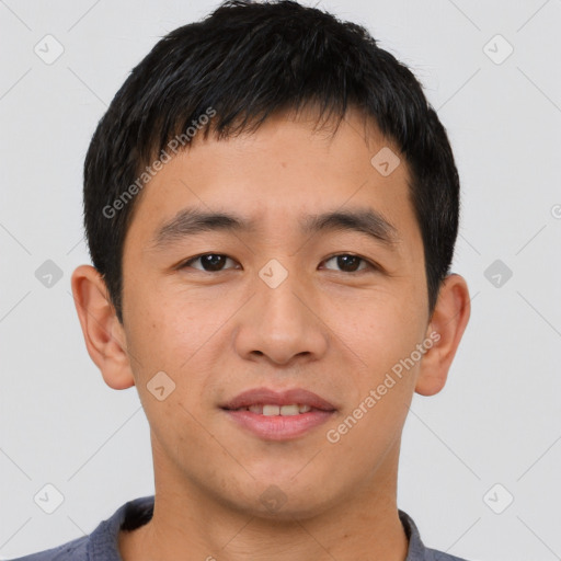 Joyful asian young-adult male with short  black hair and brown eyes