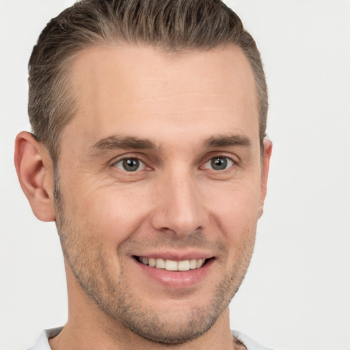 Joyful white young-adult male with short  brown hair and brown eyes