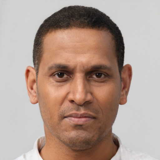 Neutral latino adult male with short  brown hair and brown eyes