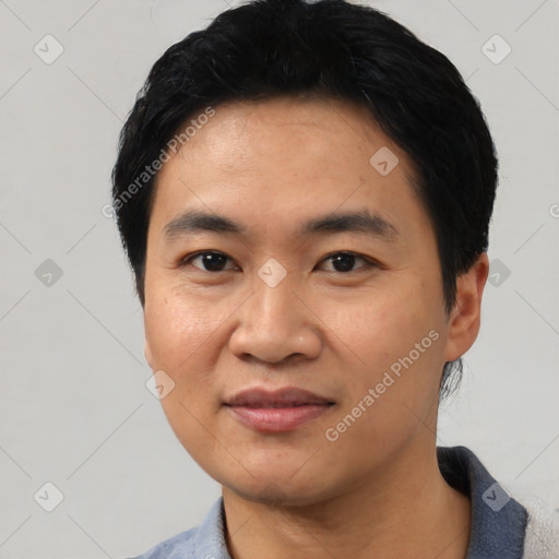 Joyful asian young-adult male with short  black hair and brown eyes