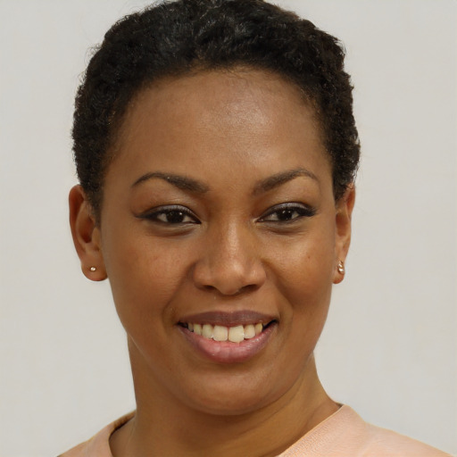 Joyful black young-adult female with short  brown hair and brown eyes