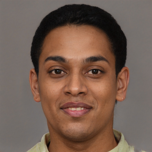 Joyful black young-adult male with short  black hair and brown eyes