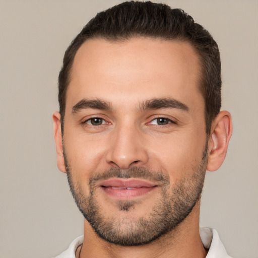 Joyful white young-adult male with short  black hair and brown eyes