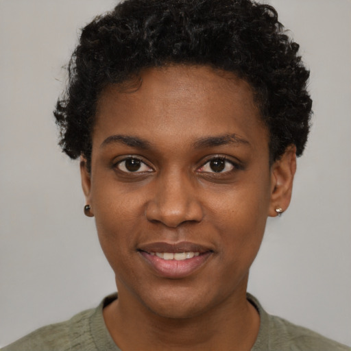 Joyful black young-adult female with short  black hair and brown eyes