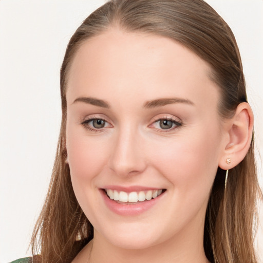 Joyful white young-adult female with long  brown hair and blue eyes