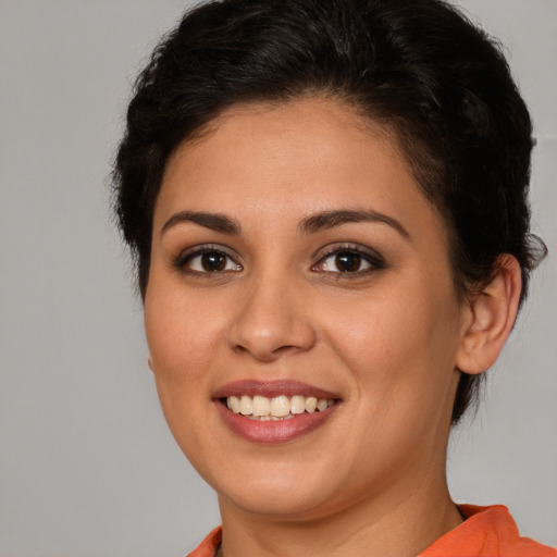 Joyful white young-adult female with medium  brown hair and brown eyes