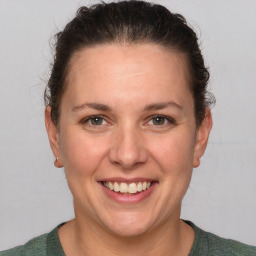 Joyful white adult female with short  brown hair and grey eyes