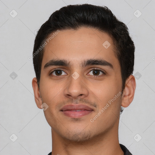 Joyful latino young-adult male with short  brown hair and brown eyes