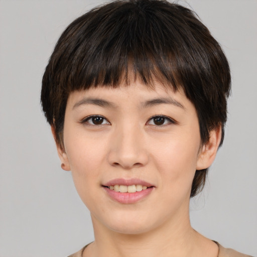 Joyful asian young-adult female with medium  brown hair and brown eyes