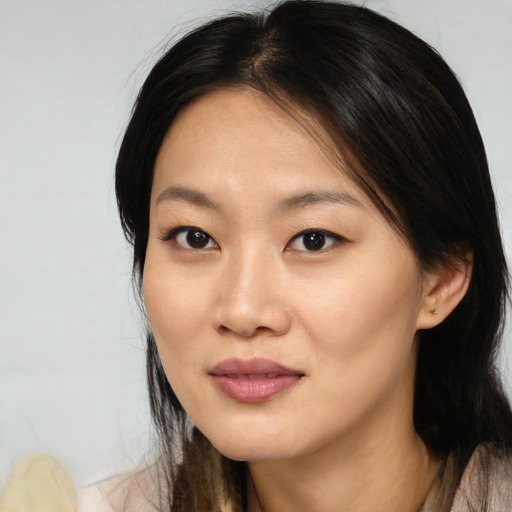 Joyful asian young-adult female with medium  brown hair and brown eyes