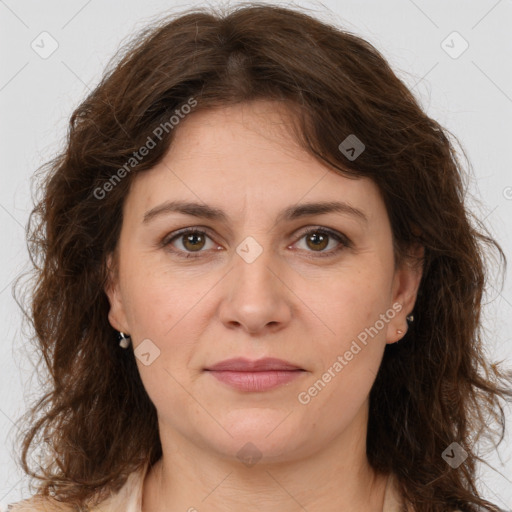 Joyful white adult female with long  brown hair and brown eyes