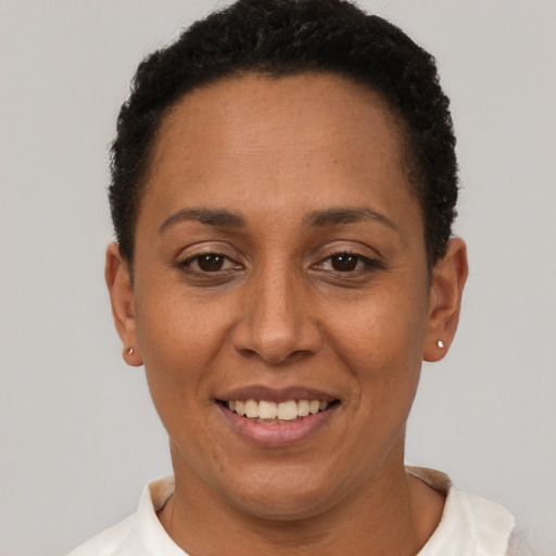 Joyful latino adult female with short  brown hair and brown eyes