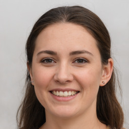 Joyful white young-adult female with long  brown hair and grey eyes