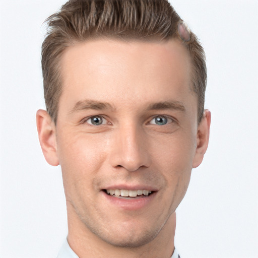 Joyful white young-adult male with short  brown hair and grey eyes