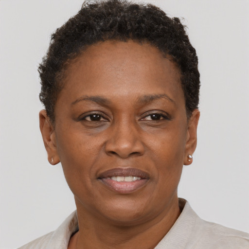 Joyful black adult female with short  brown hair and brown eyes