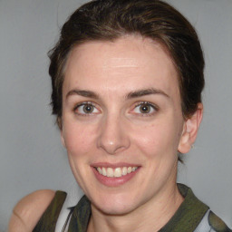 Joyful white young-adult female with medium  brown hair and green eyes