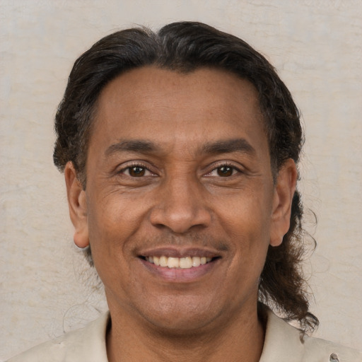 Joyful latino adult male with short  brown hair and brown eyes