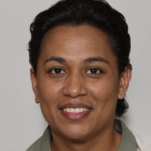 Joyful black adult female with short  black hair and brown eyes