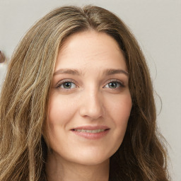 Joyful white young-adult female with long  brown hair and green eyes