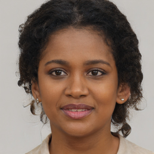 Joyful black young-adult female with medium  brown hair and brown eyes