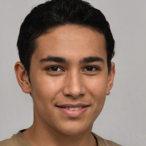 Joyful latino young-adult male with short  brown hair and brown eyes
