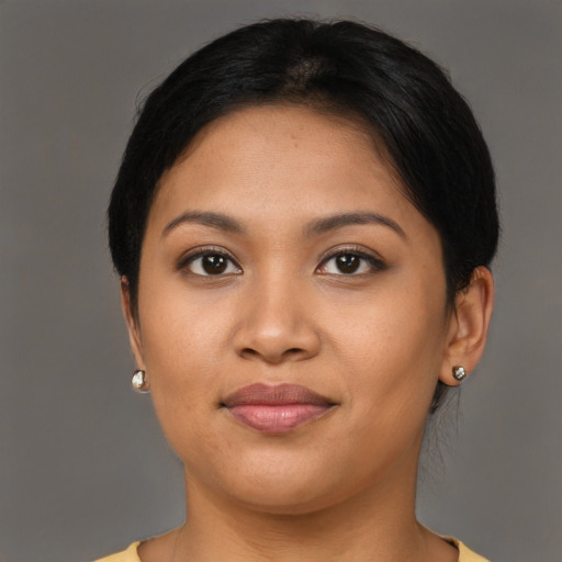 Joyful latino young-adult female with medium  brown hair and brown eyes