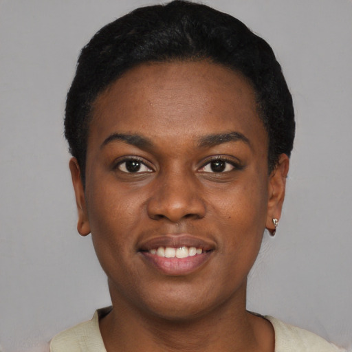 Joyful black young-adult female with short  black hair and brown eyes
