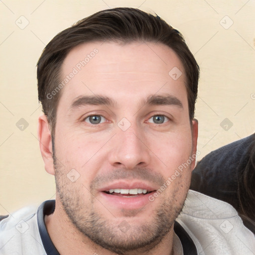 Joyful white young-adult male with short  brown hair and brown eyes