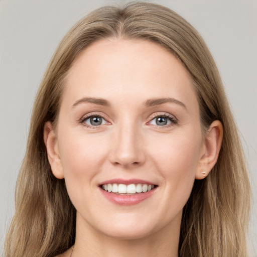 Joyful white young-adult female with long  brown hair and grey eyes