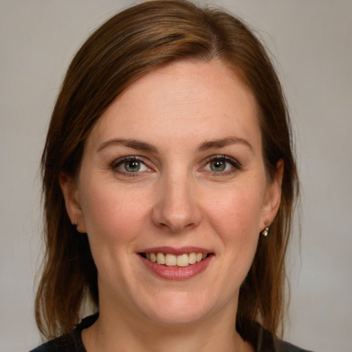 Joyful white young-adult female with medium  brown hair and blue eyes