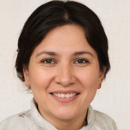 Joyful white adult female with medium  brown hair and brown eyes