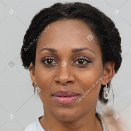 Joyful black adult female with short  brown hair and brown eyes