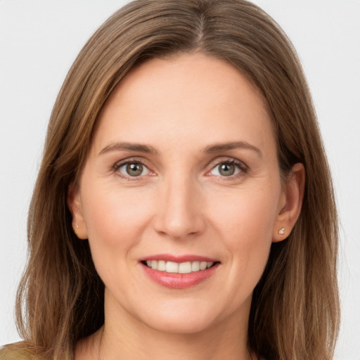 Joyful white young-adult female with long  brown hair and grey eyes