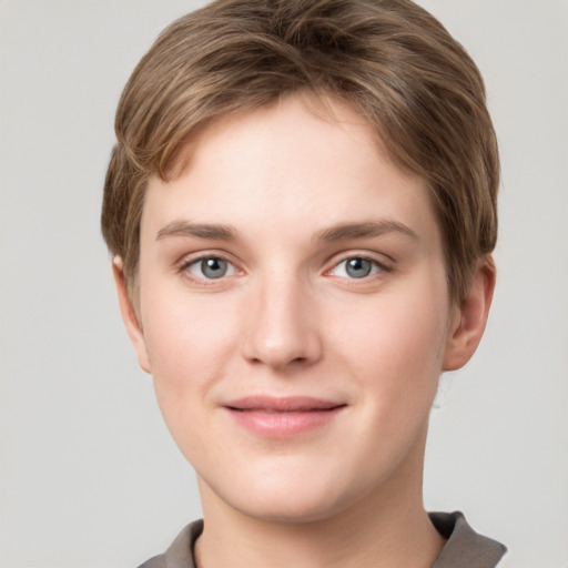 Joyful white young-adult female with short  brown hair and grey eyes