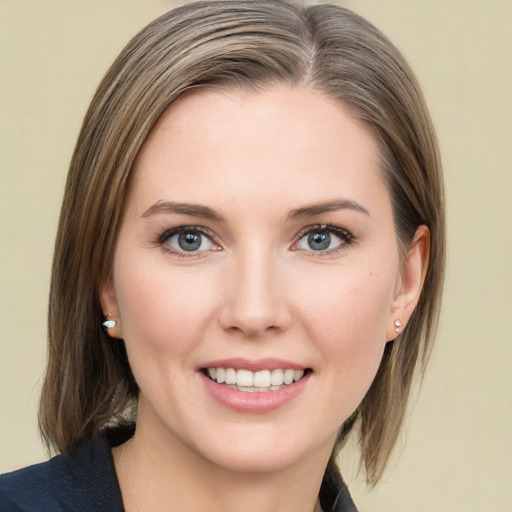 Joyful white young-adult female with medium  brown hair and green eyes