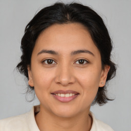 Joyful white young-adult female with medium  brown hair and brown eyes