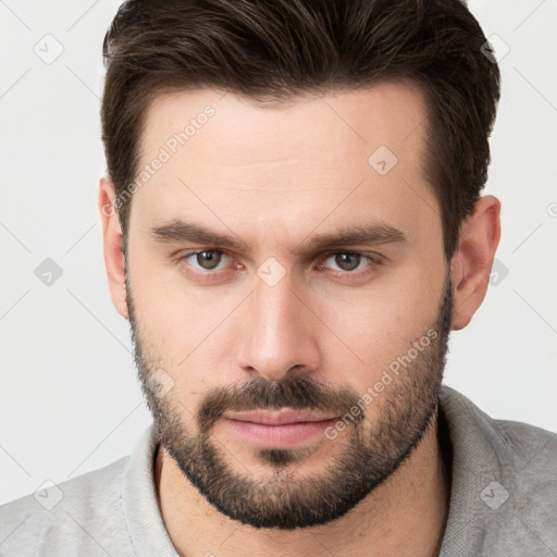 Joyful white young-adult male with short  brown hair and brown eyes