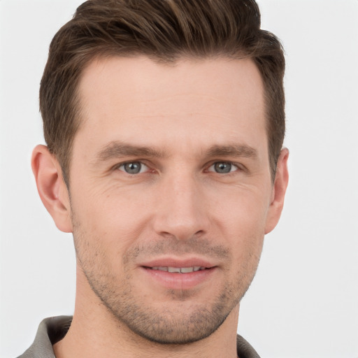 Joyful white young-adult male with short  brown hair and grey eyes