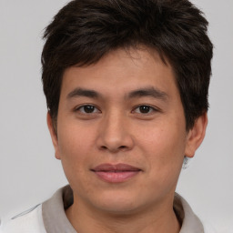 Joyful asian young-adult male with short  brown hair and brown eyes