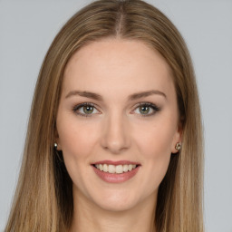 Joyful white young-adult female with long  brown hair and green eyes