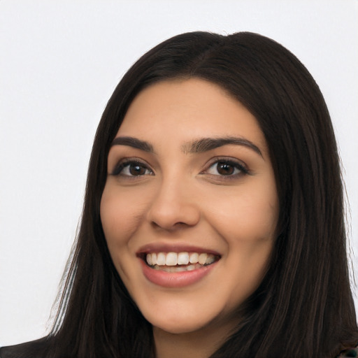 Joyful latino young-adult female with long  black hair and brown eyes