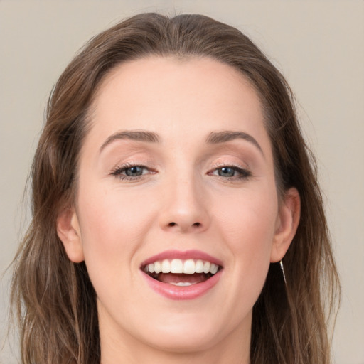 Joyful white young-adult female with long  brown hair and grey eyes