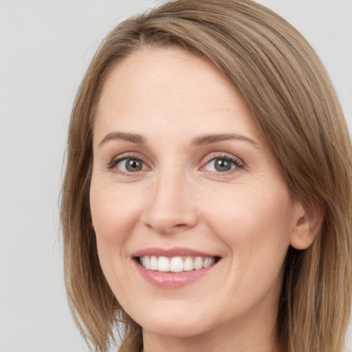 Joyful white young-adult female with long  brown hair and grey eyes