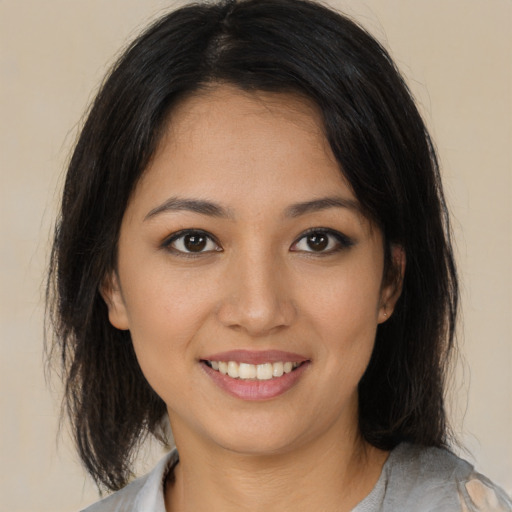 Joyful asian young-adult female with medium  brown hair and brown eyes