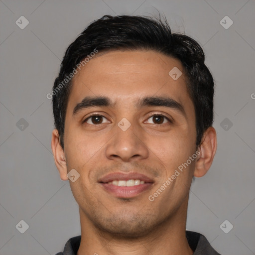 Joyful latino young-adult male with short  black hair and brown eyes